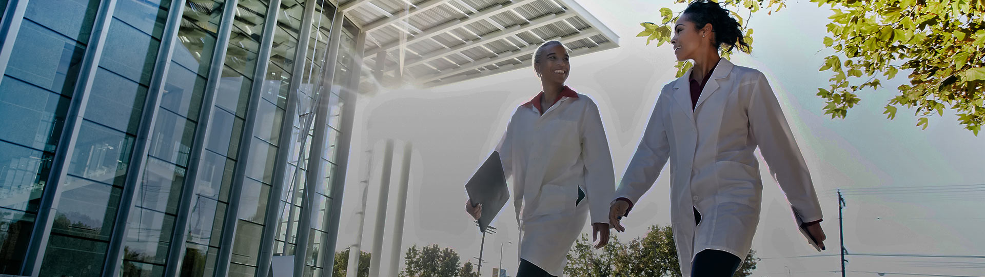 Two female doctors walking in hospital building