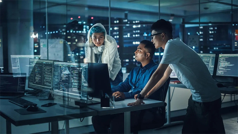 Diverse Team of Professionals Meeting in Office at Night