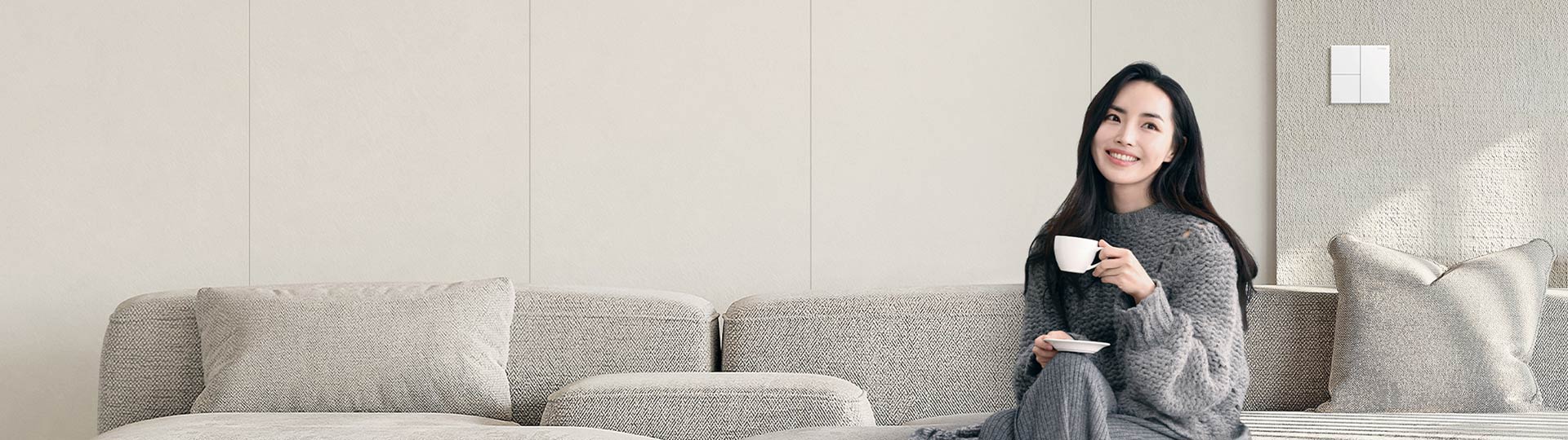 A lady sitting on the sofa drinking coffee