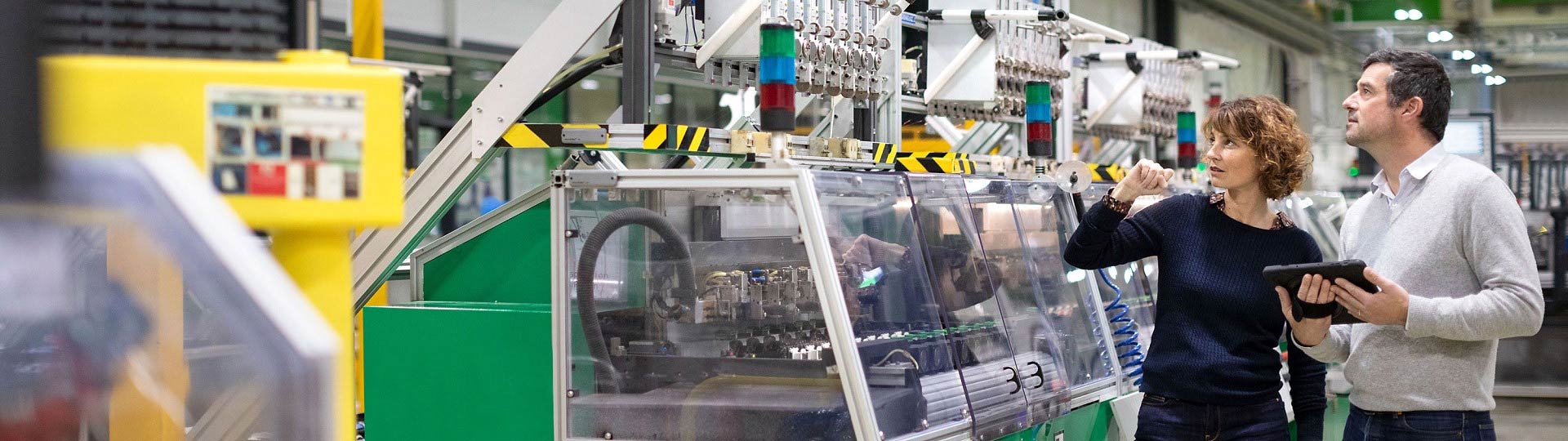 Two people communicating in the factory building