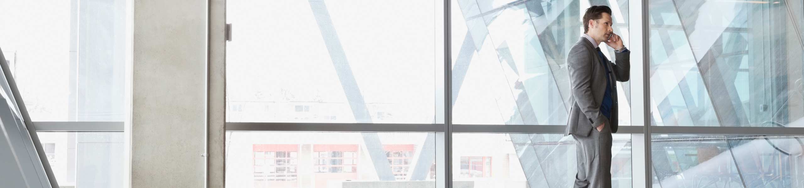 Businessman using mobile phone in office building
